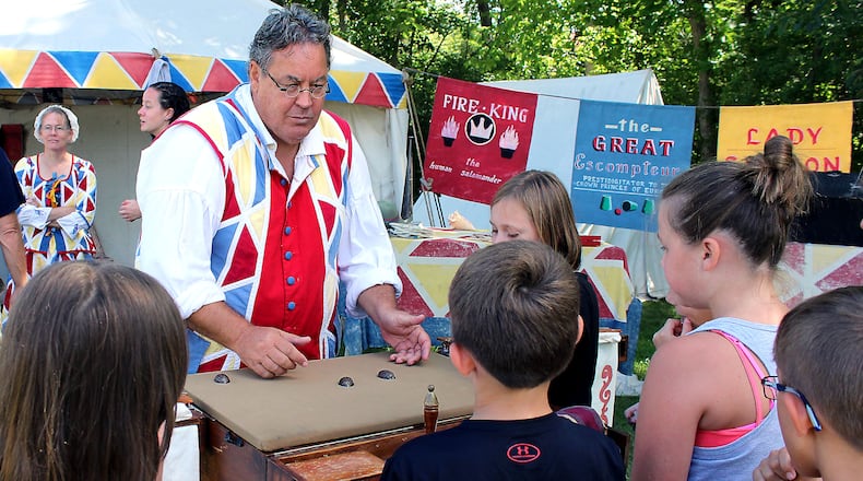 Eric Scites, a performer at The Fair at New Boston, demonstrates the “shell and pea” game for fourth grade students from Indian Valley Elementary School last September. JEFF GUERINI/STAFF