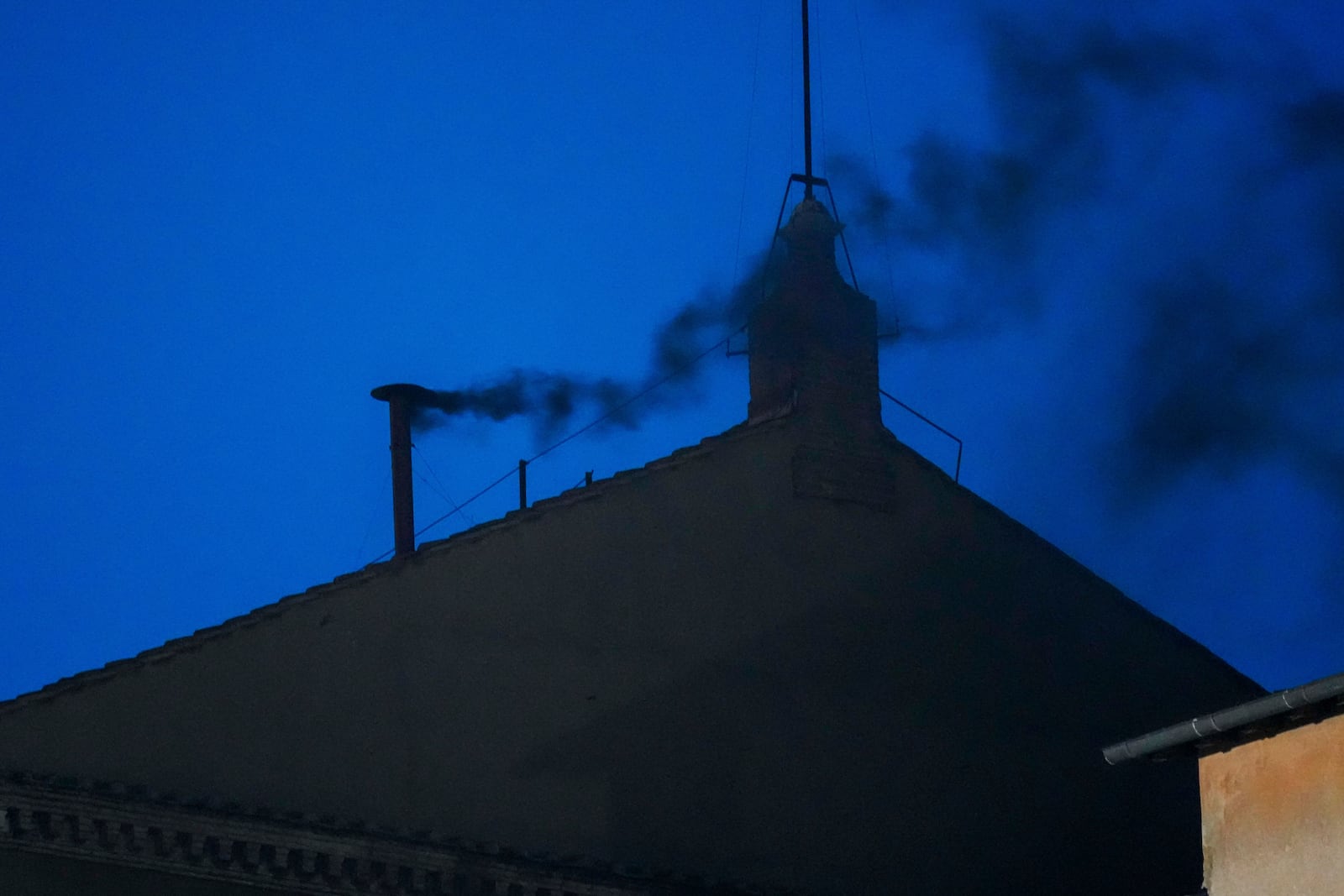 Black smoke billows from the chimney of the Sistine Chapel, where 133 cardinals are gathering on the first day of the conclave, indicating that a successor of late Pope Francis was not elected, Wednesday, May 7, 2025. (AP Photo/Gregorio Borgia)