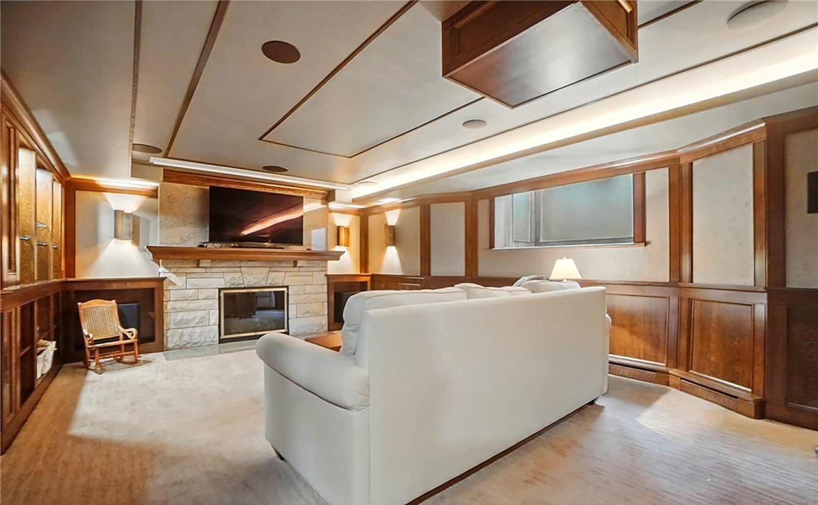 The finished basement has a state of the art media room with projector, stone fireplace and oak wainscotting.
