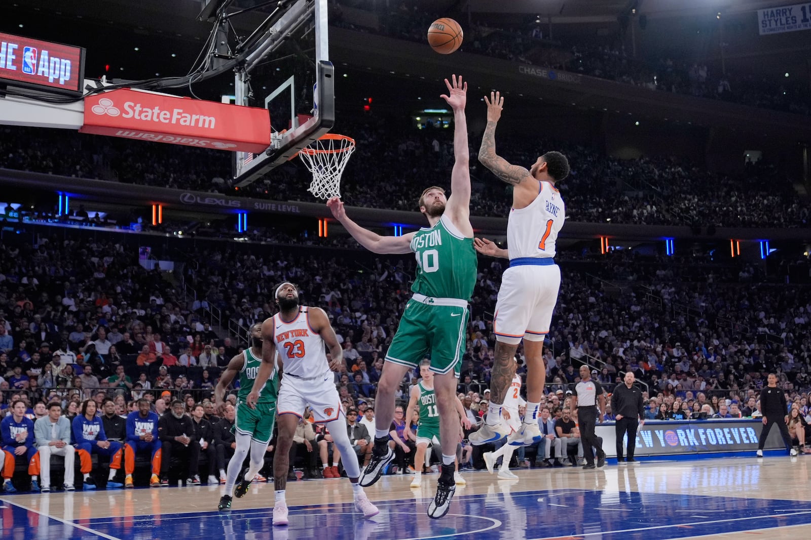 New York Knicks' Cameron Payne, right, shoots over Boston Celtics' Luke Kornet, center, during the first half of Game 3 of an NBA basketball second-round playoff series, Saturday, May 10, 2025, in New York. (AP Photo/Pamela Smith)