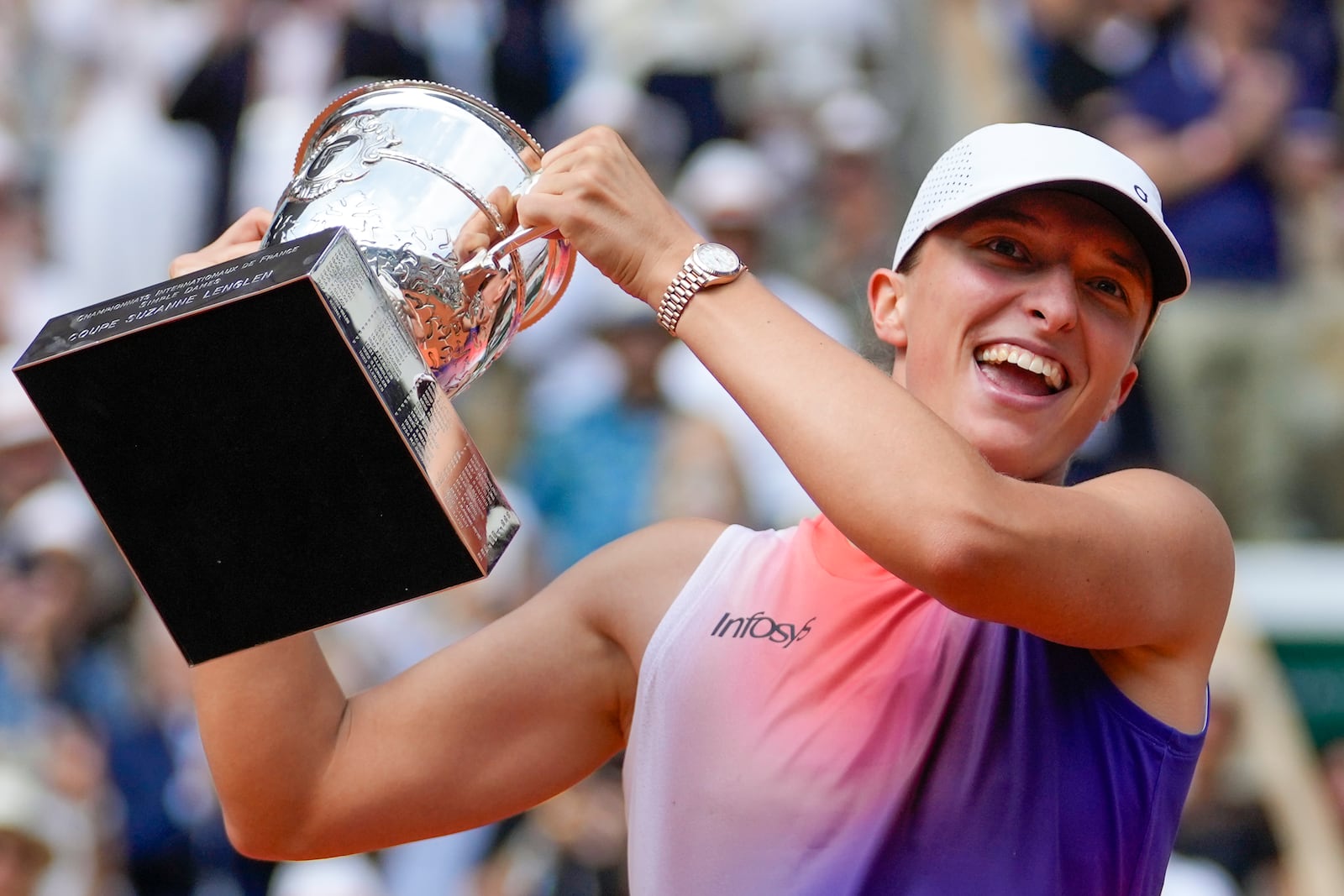 FILE - Poland's Iga Swiatek holds the trophy after winning the women's final of the French Open tennis tournament against Italy's Jasmine Paolini at the Roland Garros stadium in Paris, France, June 8, 2024. (AP Photo/Thibault Camus, File)