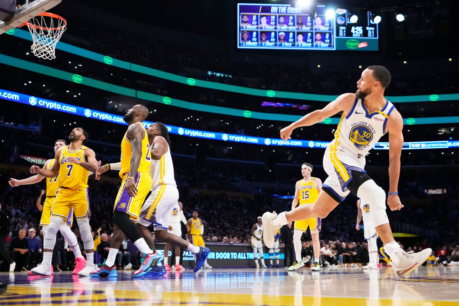 Golden State Warriors guard Stephen Curry, right, watches his shot go in during the first half of an NBA basketball game against the Los Angeles Lakers, Thursday, April 3, 2025, in Los Angeles. (AP Photo/Mark J. Terrill)