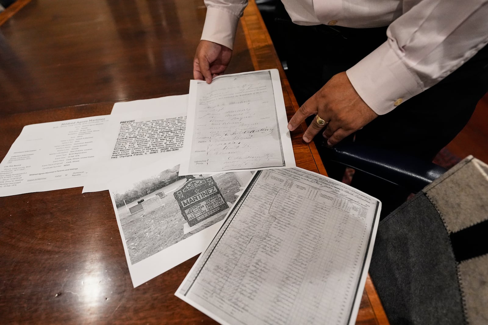 Jari Honora, family historian for the Historic New Orleans Collection, shows genealogy material of the grandparents of Pope Leo XIV in New Orleans, Friday, May 9, 2025. (AP Photo/Gerald Herbert)
