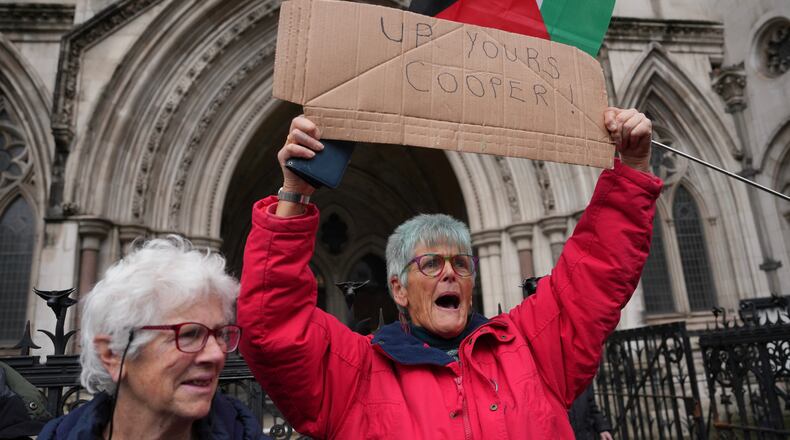 Supporters of Palestine Action stage a protest outside the Royal Court of Justice in London, Friday, Feb. 13, 2026. (AP Photo/Kin Cheung)