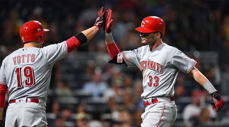 PITTSBURGH, PA - AUGUST 2: Jesse Winker #33 celebrates his solo home run with Joey Votto #19 of the Cincinnati Reds during the seventh inning against the Pittsburgh Pirates at PNC Park on August 2, 2017 in Pittsburgh, Pennsylvania. (Photo by Joe Sargent/Getty Images)