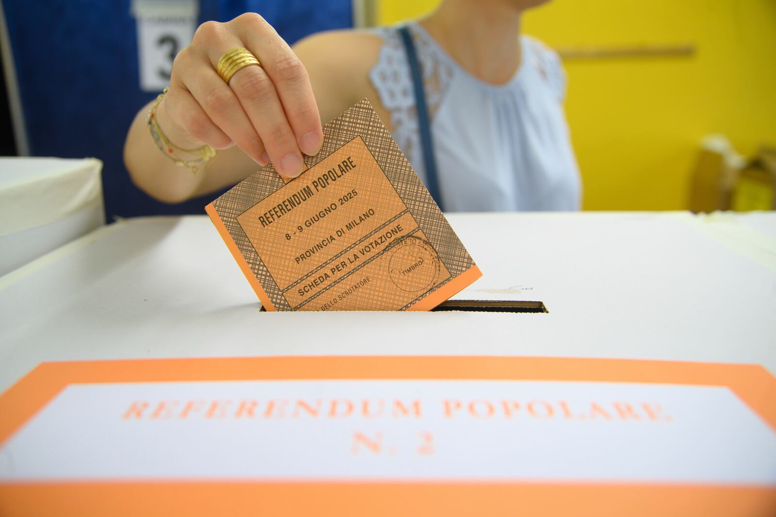 A woman casts her ballot in a box for referendums on citizenship and job protections, at a polling station in Milan, Italy, Sunday, June 8, 2025. (Claudio Furlan/LaPresse via AP)