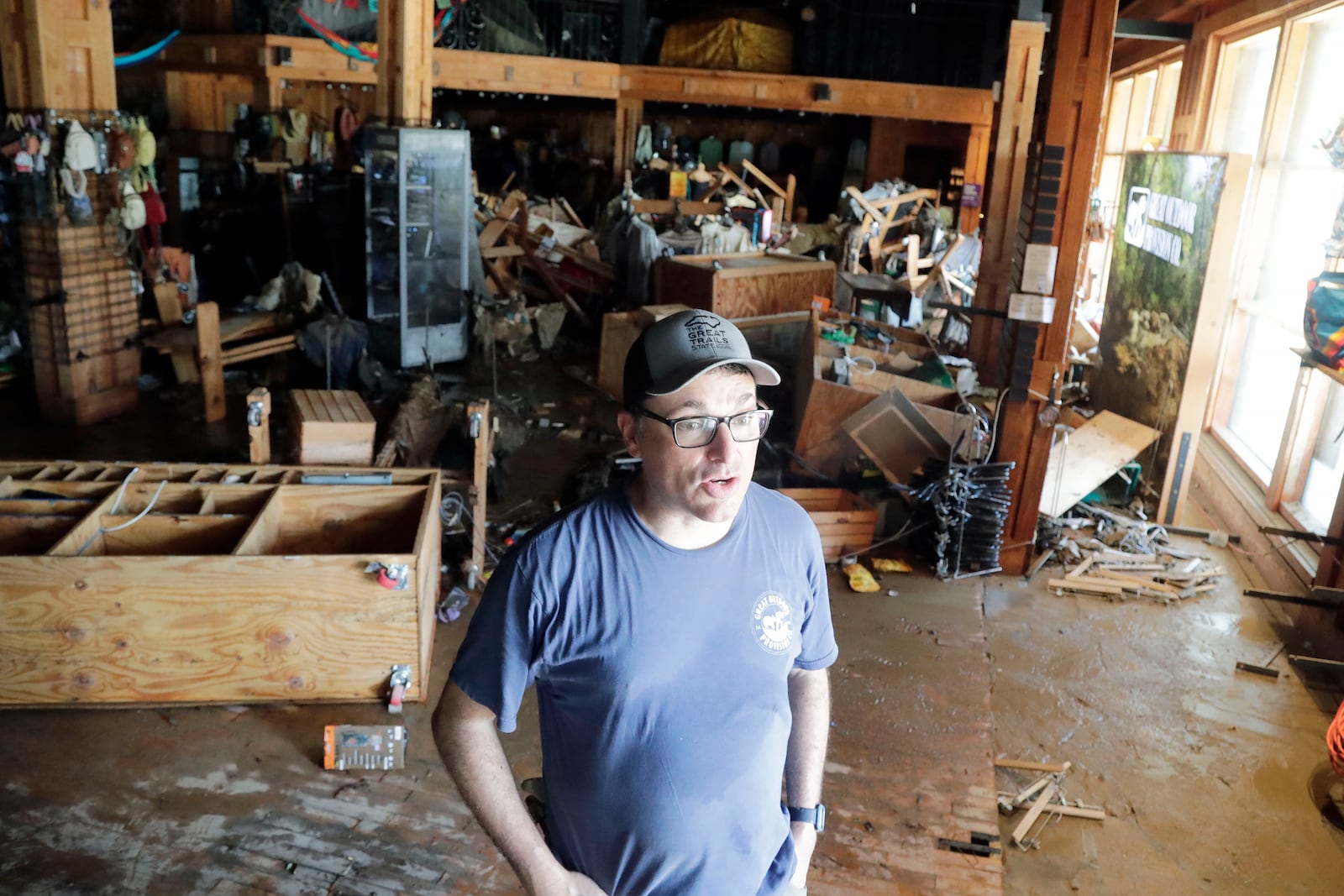 Store manager Chad Pickens talks about the damage sustained at the Great Outdoor Provision Co. after it was flooded during tropical storm Chantal, Monday, July 7, 2025, in Chapel Hill, N.C. (AP Photo/Chris Seward)