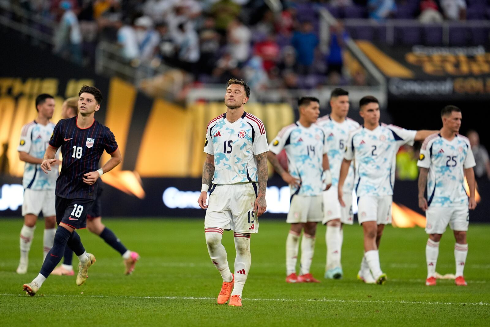 Costa Rica defender Francisco Javier Calvo Quesada (15) stands on the field with teammates after losing to the United states in penalty kicks of a CONCACAF Gold Cup quarterfinals soccer match, Sunday, June 29, 2025, in Minneapolis. (AP Photo/Abbie Parr)