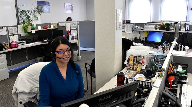 Tiffany Brown, an employee at the Red Roof Inn call center in Springfield, works at her desk taking calls from customers./Bill Lackey