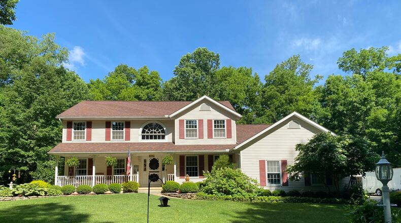 The 4-bedroom home offers about 2,870 sq. ft. of living space with a partially finished lower level. The front of the home features a 2-story entry, full-covered front porch and heavy landscaping. CONTRIBUTED PHOTO