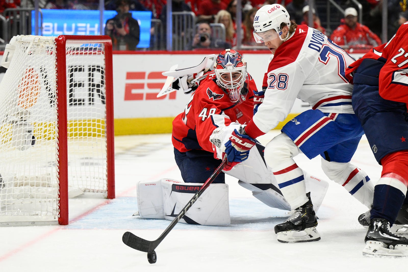 Montreal Canadiens center Christian Dvorak (28) skates with the puck against Washington Capitals goaltender Logan Thompson (48) in the second period of Game 5 of a first-round NHL hockey playoff series Wednesday, April 30, 2025, in Washington. (AP Photo/Nick Wass)