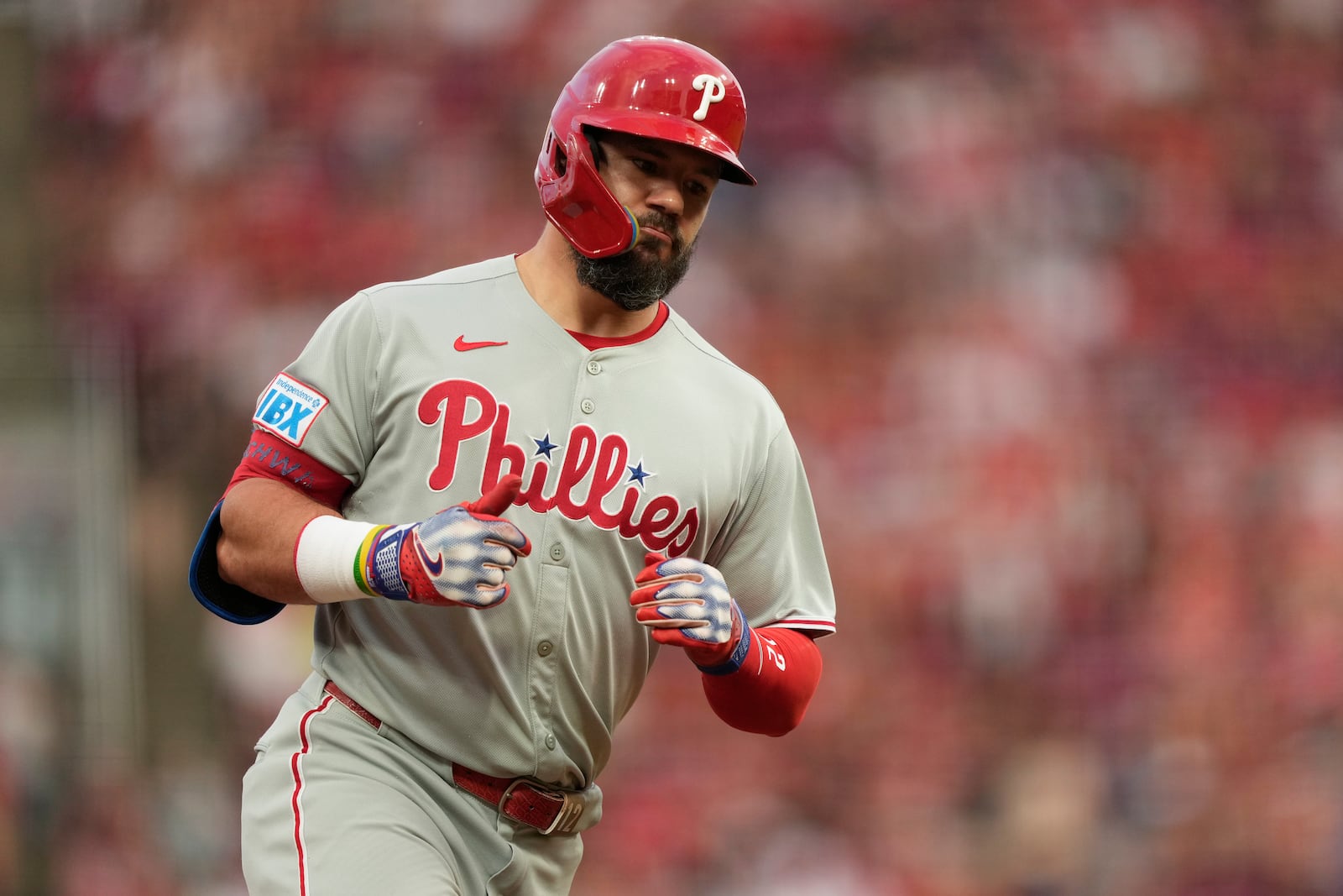 Philadelphia Phillies designated hitter Kyle Schwarber gives the thumbs-up as he rounds third base after hitting a two-run homer during the eighth inning of a baseball game against the Cincinnati Reds Monday, Aug. 11, 2025, in Cincinnati. (AP Photo/Carolyn Kaster)