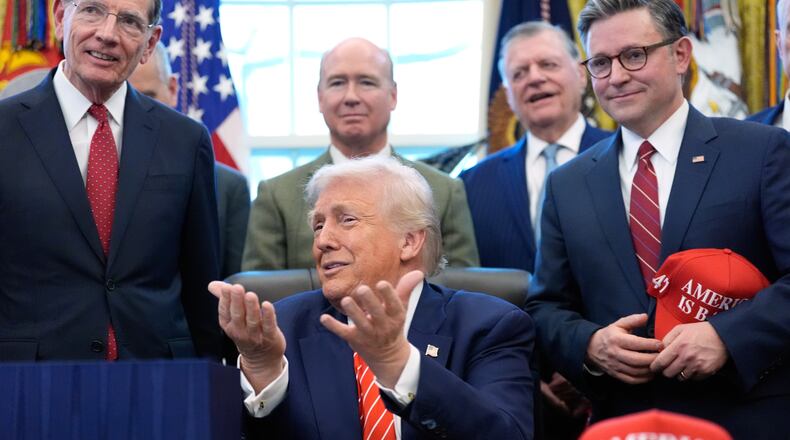 President Donald Trump speaks to reporters after signing a spending bill that ends a partial shutdown of the federal government in the Oval Office of the White House, Tuesday, Feb. 3, 2026, in Washington. (AP Photo/Alex Brandon)