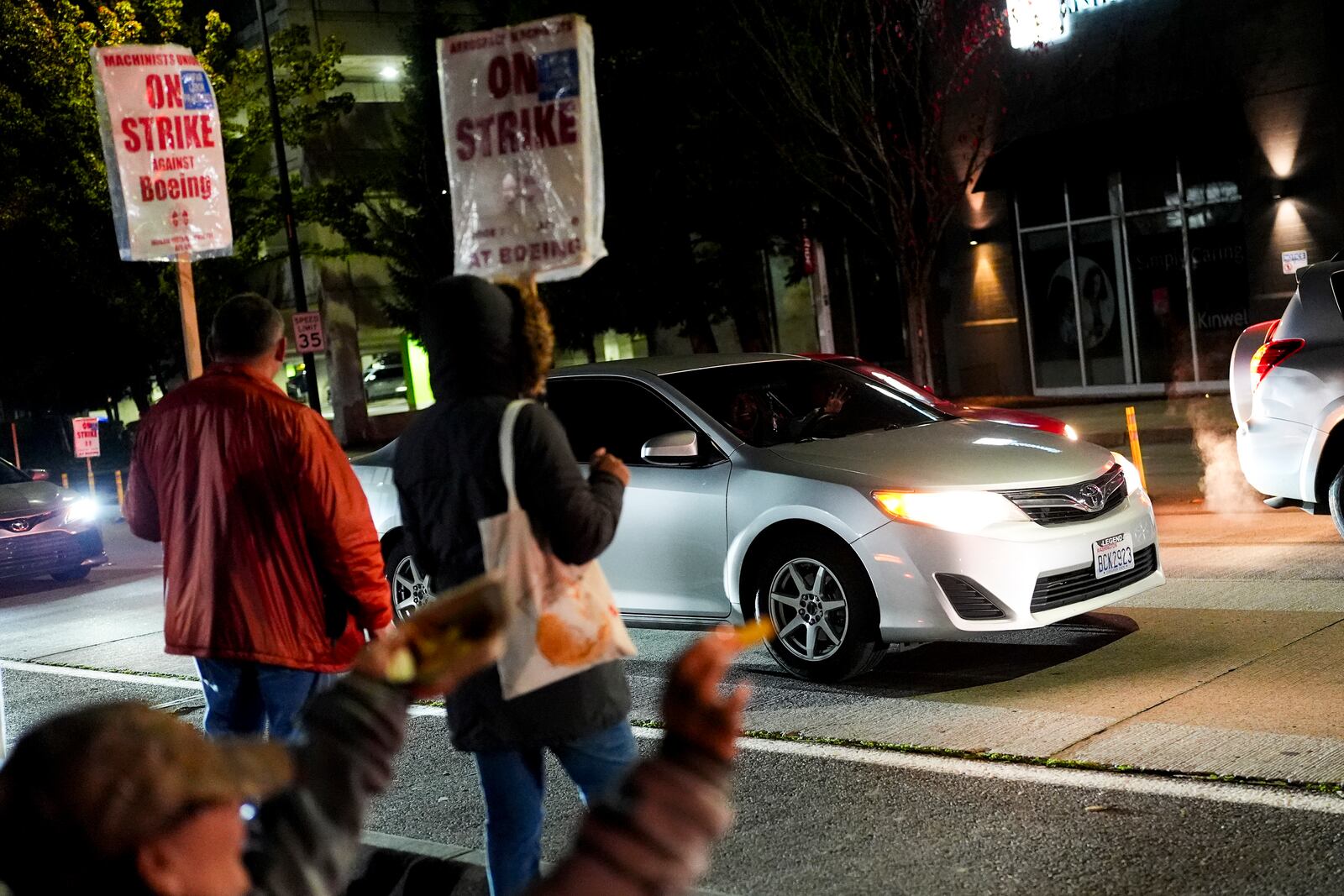 FILE - Boeing employees cheer as a driver honks and waves in support while they work the picket line after union members voted to reject a new contract offer from the company, Wednesday, Oct. 23, 2024, in Renton, Wash. (AP Photo/Lindsey Wasson, File)