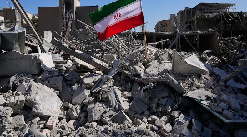 An Iranian flag is placed among the ruins of a police station struck Monday during the U.S.–Israeli military campaign in Tehran, Iran, Tuesday, March 3, 2026. (AP Photo/Vahid Salemi)