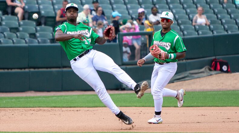 Dragons third baseman Cam Collier fires the baseball to first base while shortstop Victor Acosta backs him up Sunday at Day Air Ballpark. Jeff Gilbert/CONTRIBUTED