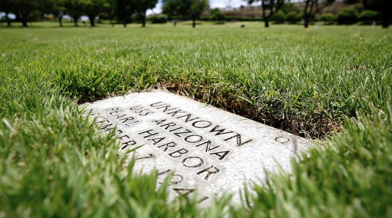 FILE - A grave marker for an unknown casualty from the USS Arizona is shown at the National Memorial Cemetery of the Pacific, July 15, 2021, in Honolulu. (AP Photo/Caleb Jones, File)