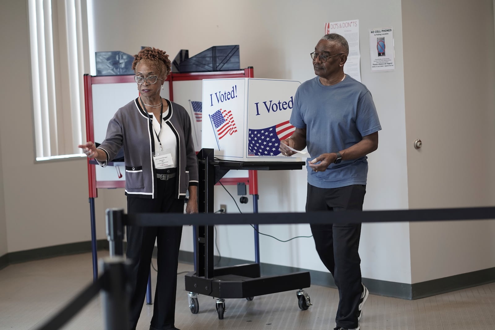 FILE - Joseph Clarkson Sr., 72, right, takes his ballot to a scanner during the South Carolina Democratic primary at a Richland County early voting site in Columbia, S.C., Jan. 26, 2024. (AP Photo/Serkan Gurbuz, File)