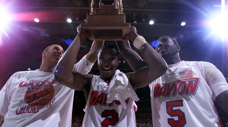 03/15/03 Dayton\'s Brooks Hall, D.J. Stelly, and Nate Green hold up the A-10 championship trophy after defeating Temple on Saturday afternoon.