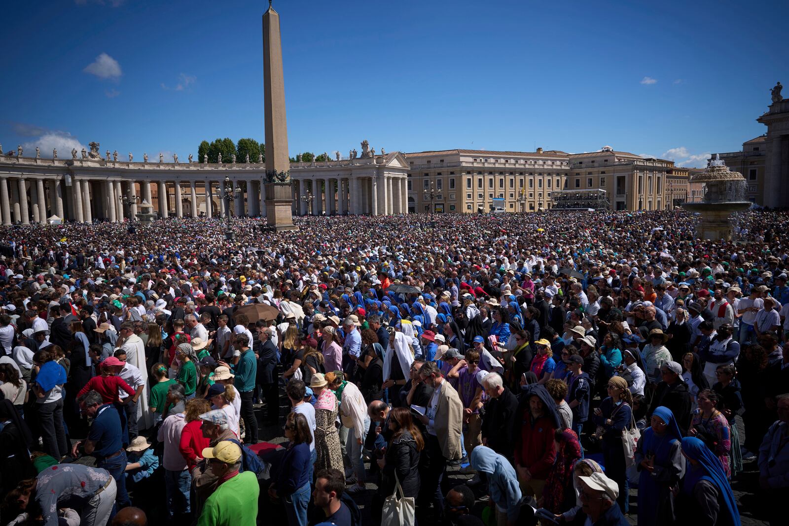 Faithful listen to mass during the funeral of Pope Francis in St. Peter's Square at the Vatican, Saturday, April 26, 2025. (AP Photo/Emilio Morenatti)