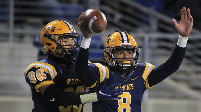 Springfield's Te'Sean Smoot, right, and Delian Bradley celebrate a touchdown in the first half against St. Edward in the Division I state championship game on Friday, Dec. 3, 2021, at Tom Benson Hall of Fame Stadium in Canton. Smoot (quarterback) and Bradley (safety) were named first-team, All-Ohio on Thursday. Smoot also was named the co-offensive player of the year in Division I. David Jablonski/Staff