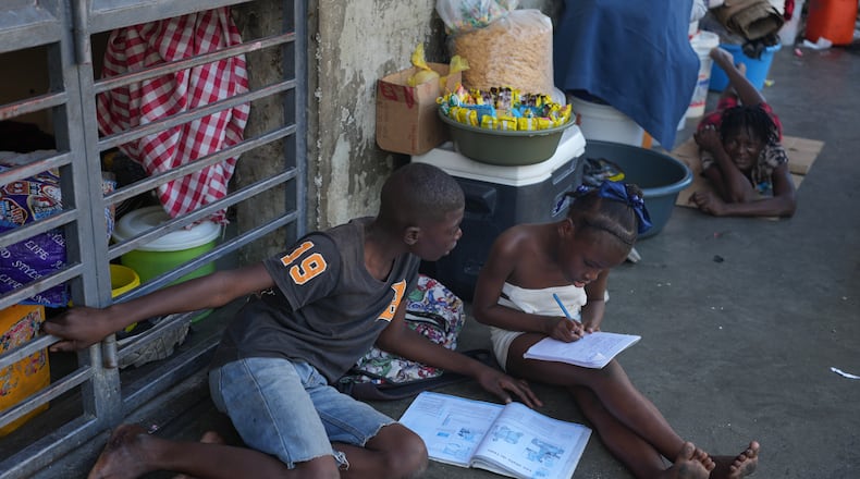Children do their homework at a shelter for families displaced by gang violence in Port-au-Prince, Haiti, Tuesday, Jan. 27, 2026. (AP Photo/Odelyn Joseph)