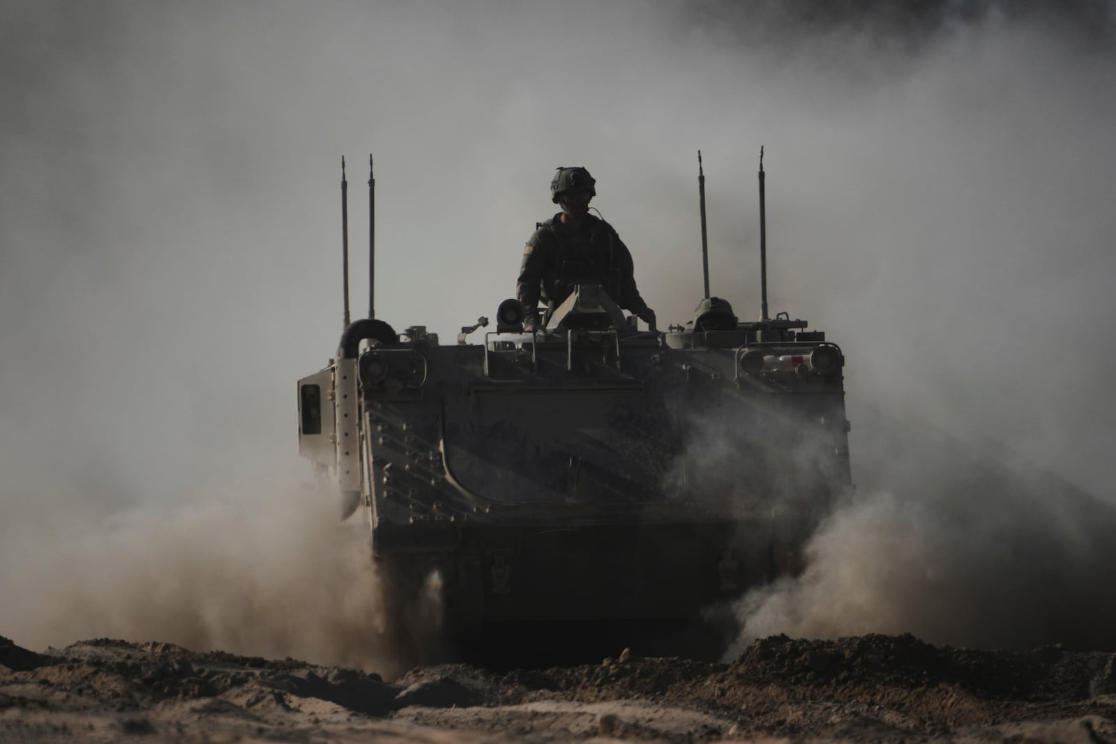 Israeli troops move with APC, armored personnel carrier near the border with Gaza, in southern Israel, Thursday, May 8, 2025. (AP Photo/Ariel Schalit)