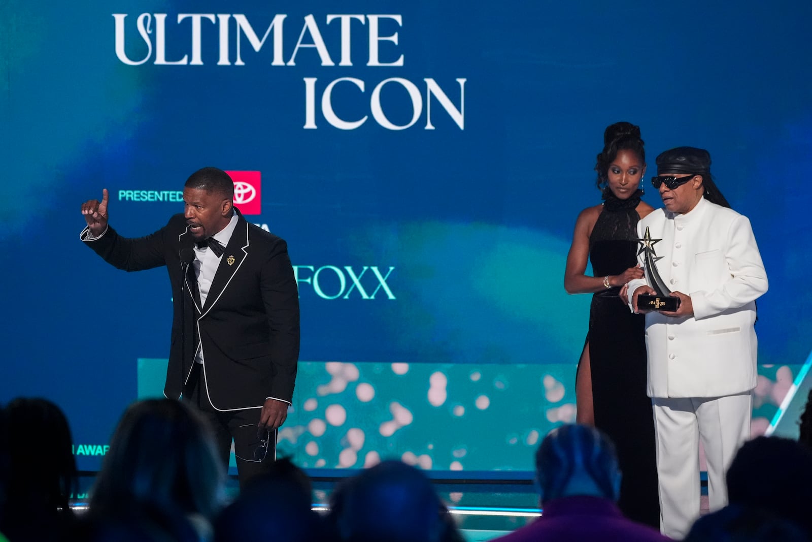 Jamie Foxx accepts the ultimate icon award during the BET Awards on Monday, June 9, 2025, at the Peacock Theater in Los Angeles. Stevie Wonder looks on from right. (AP Photo/Chris Pizzello)