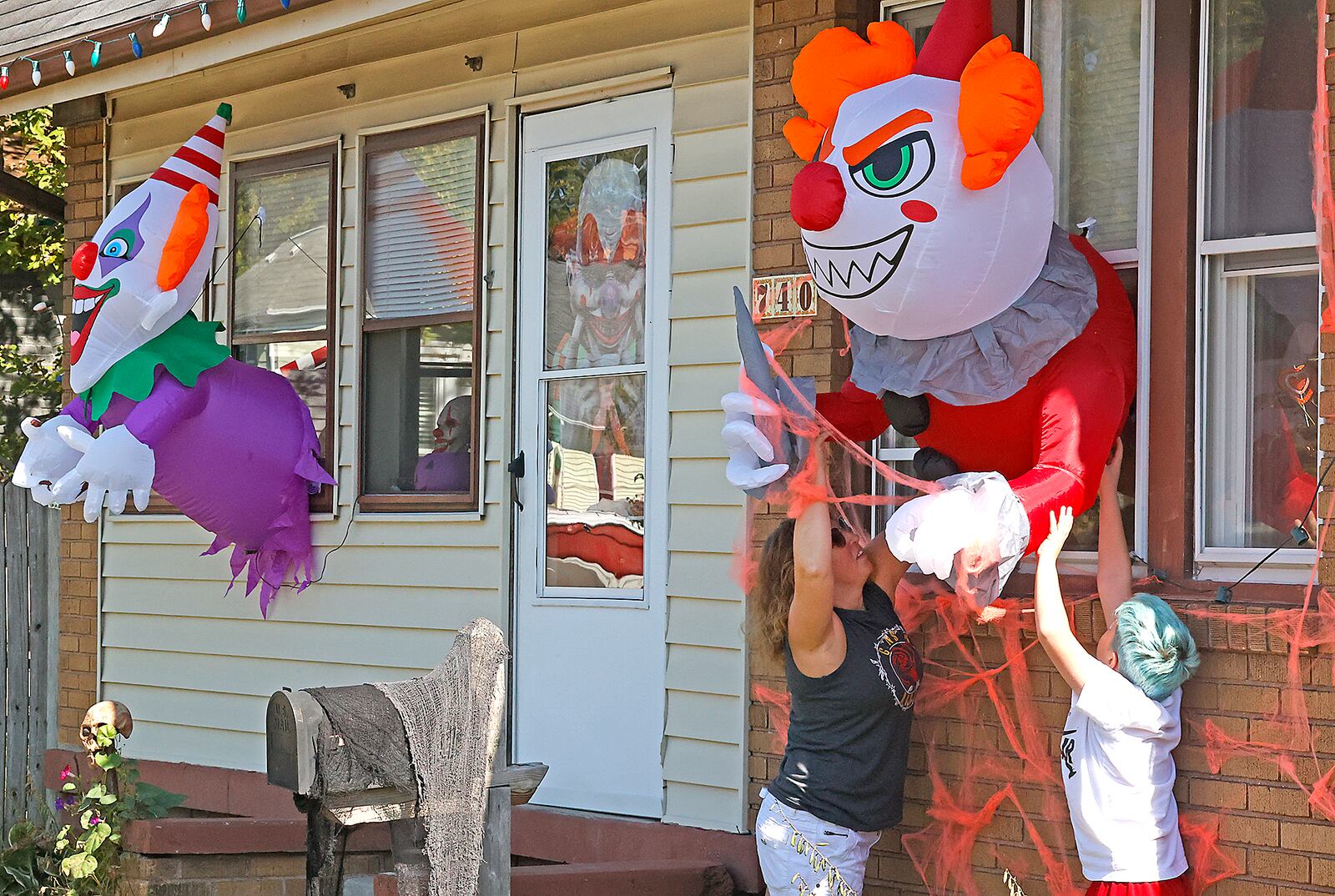 Arretta Adrian and her son, Corbin, are decorating their house along Rodgers Drive with a "Killer Clown" theme for Halloween Monday, Oct. 2, 2023. BILL LACKEY/STAFF