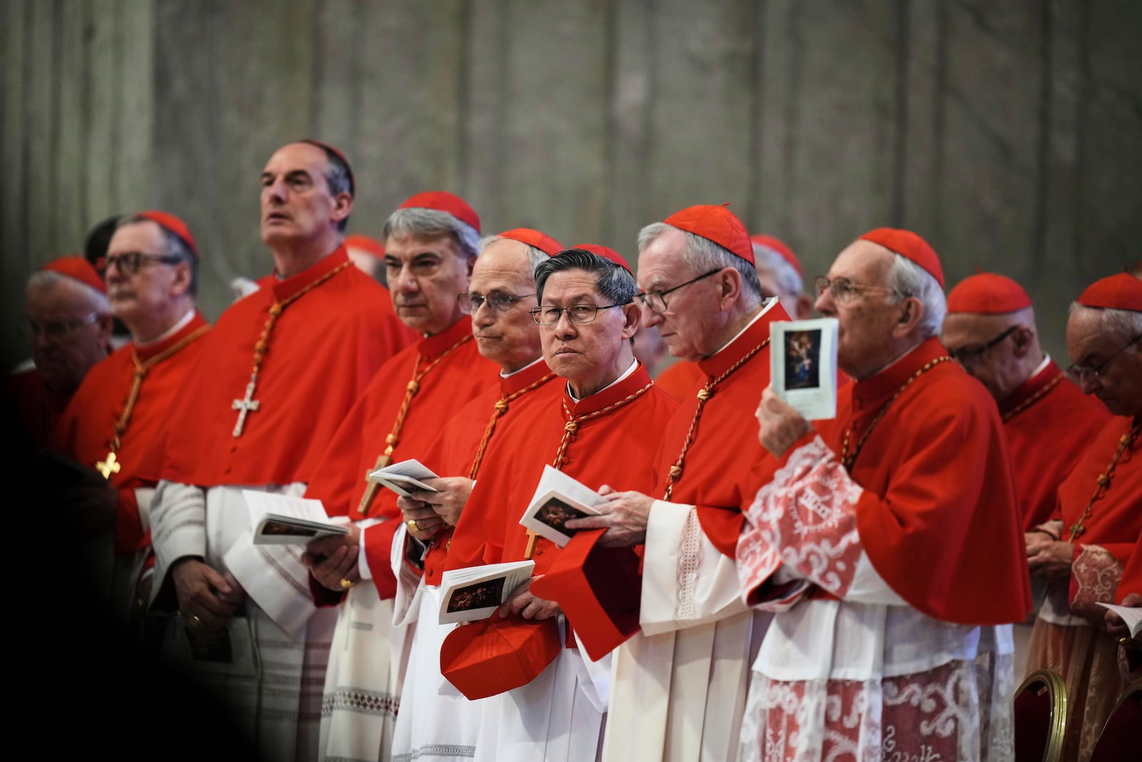 FILE - Cardinal Luis Antonio Tagle, center, takes part in the procession carrying the body of Pope Francis to St. Peter's Basilica at the Vatican, Wednesday, April 23, 2025, where he will lie in state for three days. (AP Photo/Alessandra Tarantino, File)