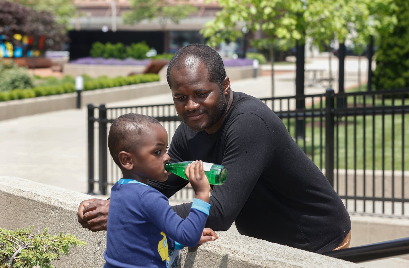 John Delia Jr., center, watches his son Baron Delia, 3, drink San Pellegrino on Thursday, May 29, 2025, at City Hall Plaza. JOSEPH COOKE/STAFF