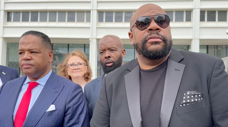 FILE - Isaac Hayes III, right, and his attorney address reporters outside a federal courthouse in Atlanta, Sept. 3, 2024. (AP Photo/Kate Brumback, File)