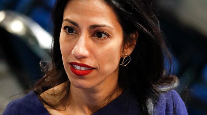 Huma Abedin, an aide to Democratic presidential candidate Hillary Clinton, talks on the floor of the Democratic National Convention in Philadelphia, Tuesday, July 26, 2016. (AP Photo/Paul Sancya)