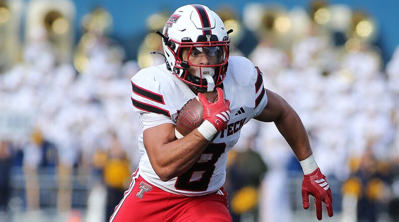 Texas Tech running back Cameron Dickey (8) runs against West Virginia during the first half of an NCAA college football game Saturday, Nov. 29, 2025, in Morgantown, W.Va. (AP Photo/Kathleen Batten)
