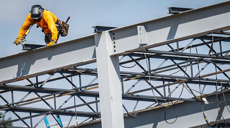 A worker welds support beams on a large building under construction on South Gettysburg Avenue. The Buckeye State netted 61,400 new jobs in 2024, up from 58,800 in 2023.