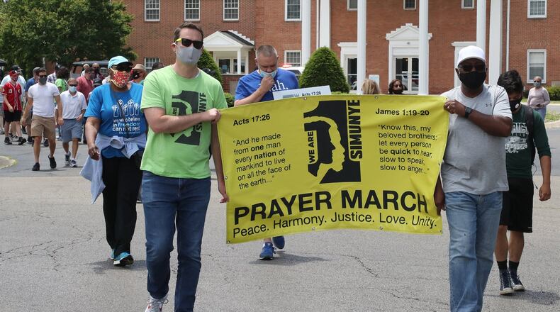 Members of the clergy from several Springfield churches along with area residents and members of law enforcement participated in a six-mile Prayer March Sunday to show unity against racial injustice. The march started at the Southgate Baptist Church on South Center Blvd. and ended at the Cornerstone Baptist Church at the intersection of North Limestone and Rosscommon Drive. The marchers stopped at several churches along the parade route to pray. BILL LACKEY/STAFF