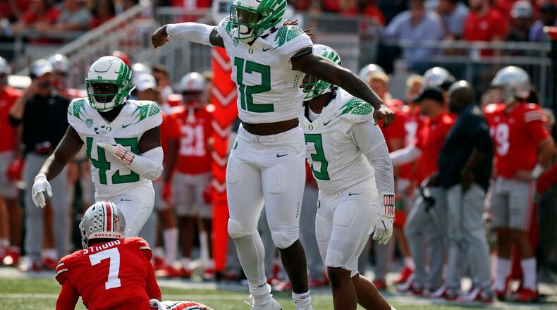 Oregon defensive end DJ Johnson, front, celebrates his sack of Ohio State quarterback C.J. Stroud on the final play of the game in the second half of an NCAA college football game Saturday, Sept. 11, 2021, in Columbus, Ohio. Oregon beat Ohio State 35-28. (AP Photo/Jay LaPrete)