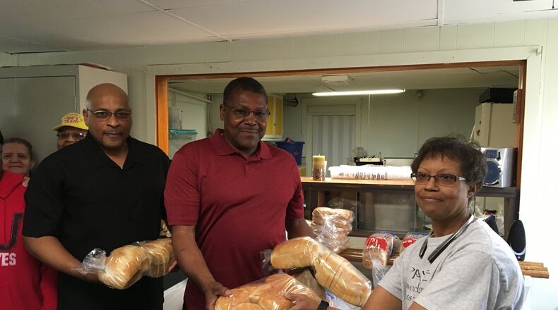 House of Prayer Outreach Ministries Pastor Ricardo Warfield, left, Alonzo McCoy and Edith Davis offer bread and baked goods along with a variety of other food items at the church’s food pantry, which opened in January at 1403 S. Yellow Springs St. Contributed photo