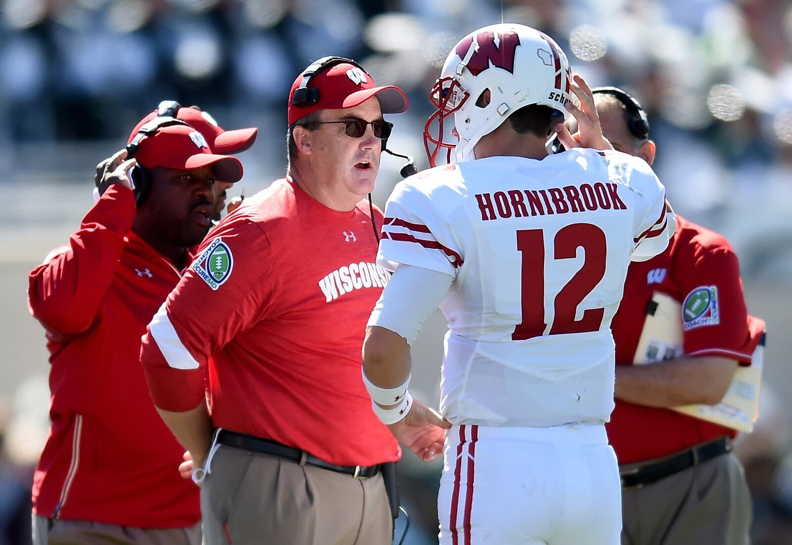 Wisconsin coach Paul Chryst talks to Alex Hornibrook during a game against Michigan State at Spartan Stadium on September 24, 2016 in East Lansing, Michigan. (Photo by Bobby Ellis/Getty Images)