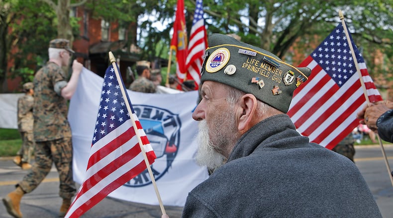 Veteran Tom Doughman joined hundreds of people as they put on their best red, white and blue attire and came out to watch the Springfield Memorial Day Monday, May 27, 2024. Men, women and children waved American flags and cheered as the parade marched by with veterans, flags, firetrucks and bands paying tribute to the nations fallen service men and women. BILL LACKEY/STAFF