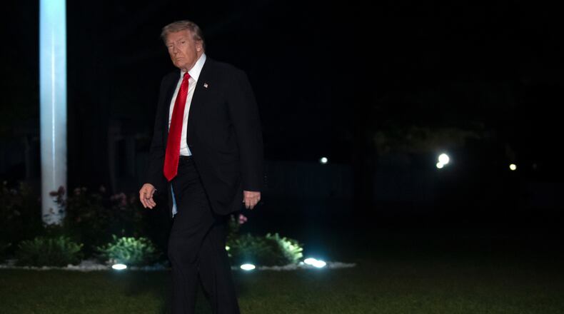 President Donald Trump walks across the South Lawn of the White House, Sunday, Nov. 2, 2025, in Washington, after returning from a trip to Florida. (AP Photo/Mark Schiefelbein)