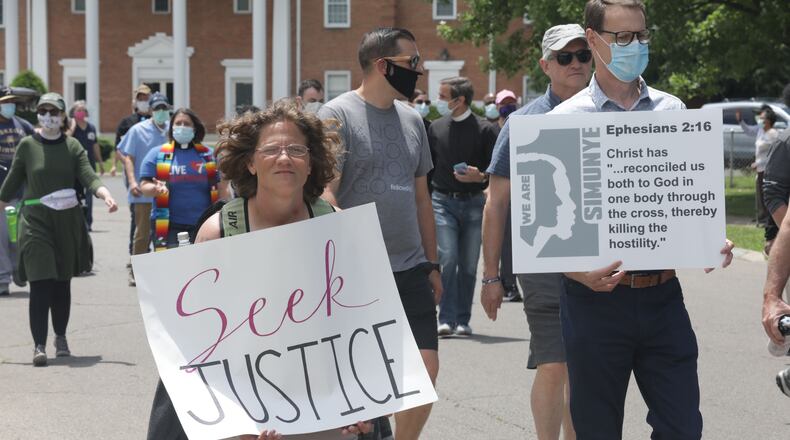 A group of Springfield clergy are leading a six-mile march through the city this afternoon to call attention to discrimination, police brutality, racial profiling and unequal treatment under the law for minorities. BILL LACKEY/STAFF
