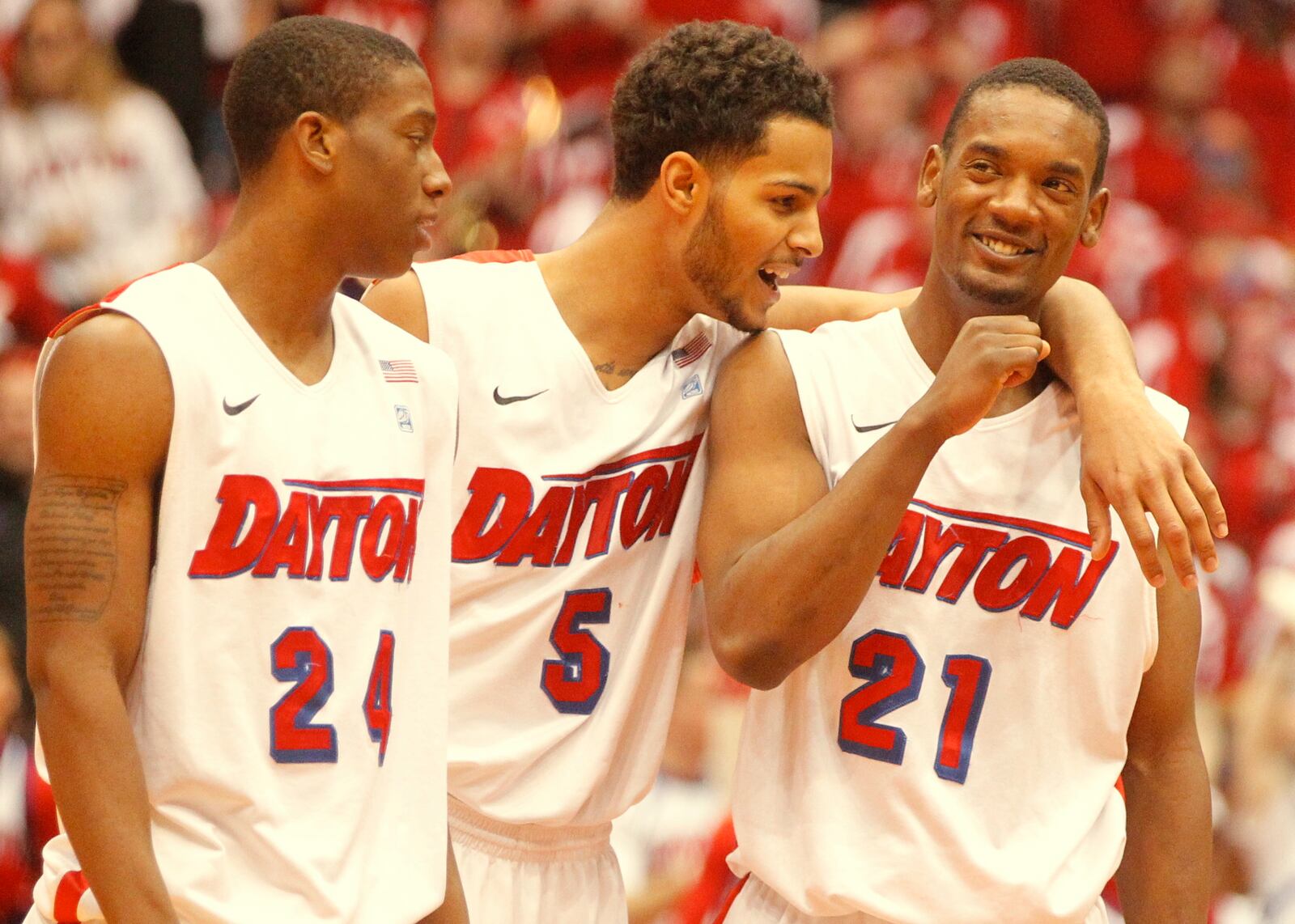 Dayton’s Jordan Sibert, left, Devin Oliver, center, and Dyshawn Pierre celebrate in the final seconds of a victory against Massachusetts on Saturday, March 1, 2014, at UD Arena. David Jablonski/Staff