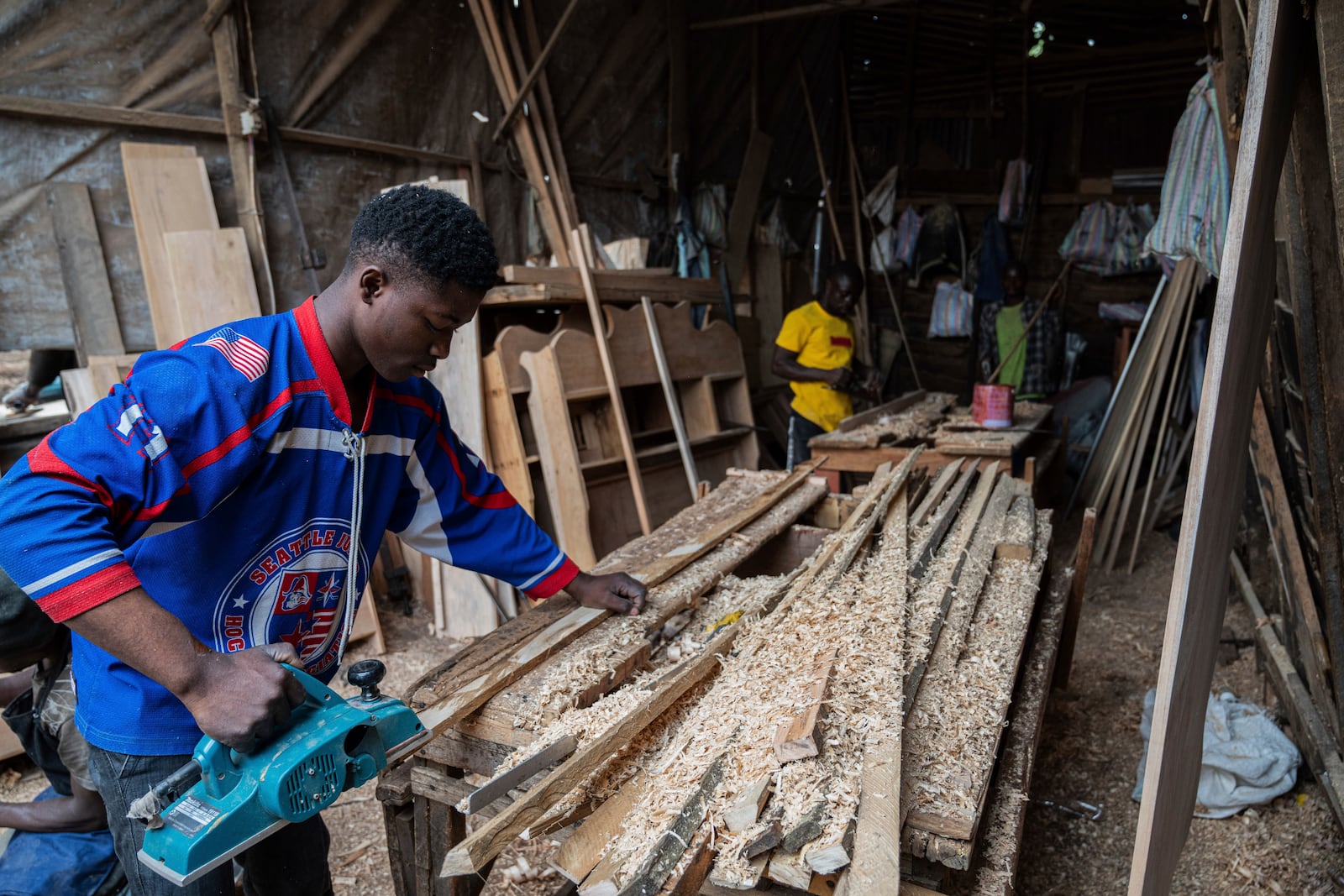 Diode works in a carpentry shop powered in part by solar energy in Goma, Congo, May 23, 2024. (AP Photo/Moses Sawasawa)