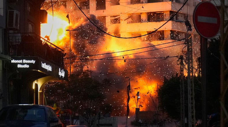 An explosion erupts from a building following an Israeli strike in central Beirut, Lebanon, Wednesday, March 18, 2026. (AP Photo/Hussein Malla)