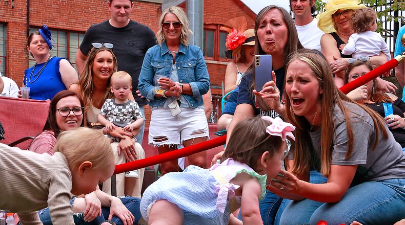 Louisville wasn't the only place to see racing action Saturday, May 6, 2023. Mother Stewart's Brewery held their first Crawl For The Roses as part of their Derby Day event celebrating the running of the Kentucky Derby. Instead of horses, however, Mother Stewart's race featured babies. Two heats of parents released their tiny thoroughbreds and cheered them on as they raced on all fours to the waiting arms of the other parent. Liam Zawada, 14 months, was the winner of the championship heat. He and his mother received an award for being the first Crawl for the Roses champion. BILL LACKEY/STAFF