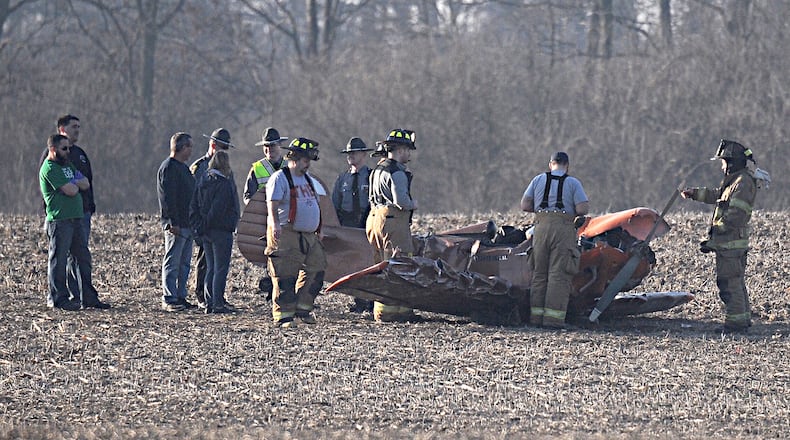 Emergency personel look over a single engine plane that crashed near Titus Road in Clark County Sunday evening. Marshall Gorby/Staff