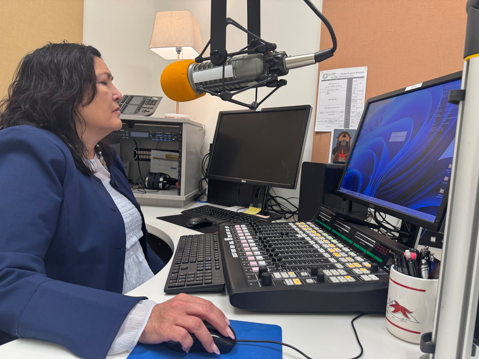Jaclyn Sallee, president and chief operating for Koahnic Broadcast Corp.,starts a computer July 10, 2025, at the Anchorage, Alaska, studios of KBNA, the flagship station for National Native News. (AP Photo/Mark Thiessen)