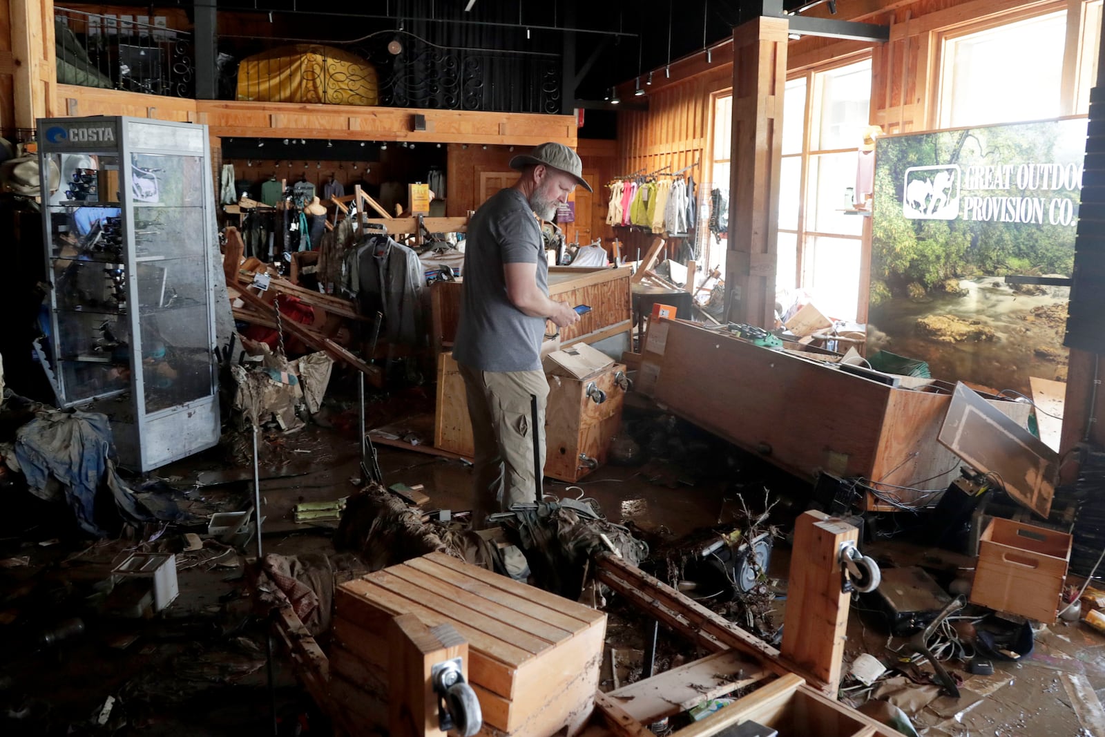 An employee surveys the damage at the Great Outdoor Provision Co. after it was flooded during tropical storm Chantal, Monday, July 7, 2025, in Chapel Hill, N.C. (AP Photo/Chris Seward)