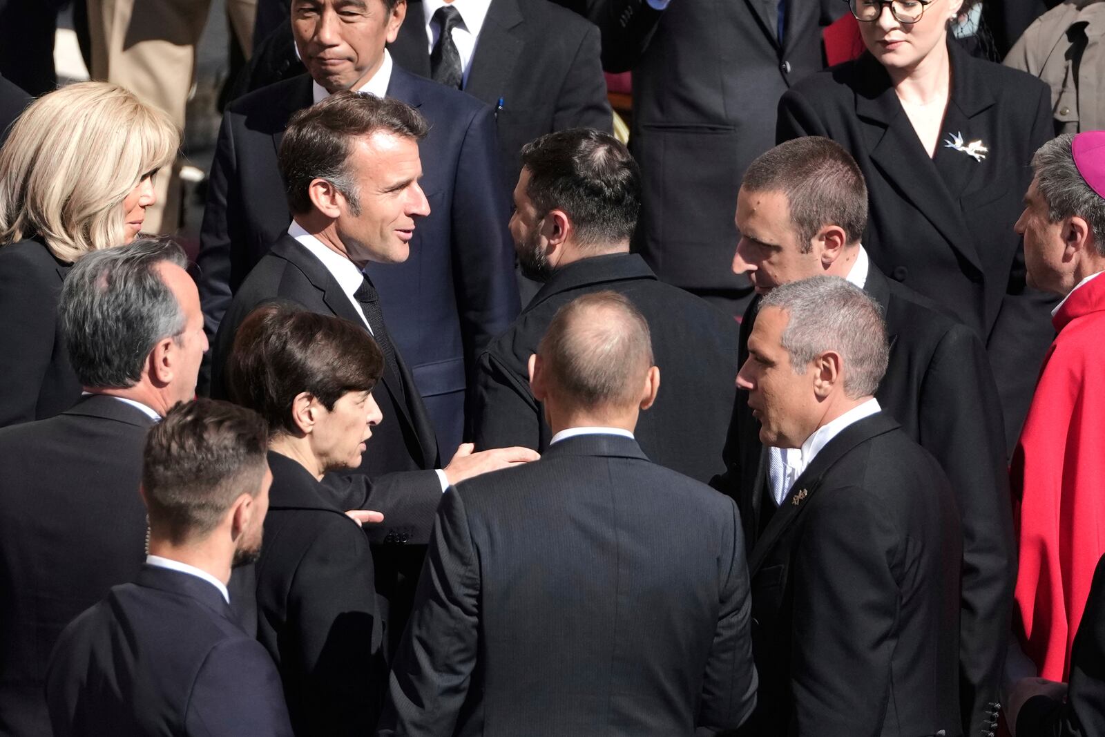 French President Emmanuel Macron, center left, speaks with Ukraine's President Volodymr Zelenskyy, center right, as they arrive for the funeral of Pope Francis in St. Peter's Square at the Vatican, Saturday, April 26, 2025. (AP Photo/Markus Schreiber)
